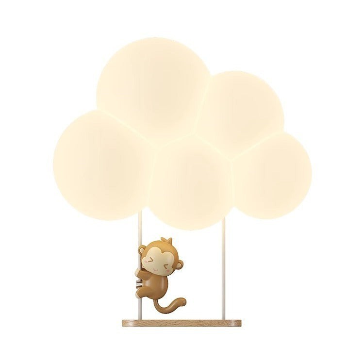 Applique murale enfant Lumeoo KIDIWALL en forme de nuage lumineux avec un petit singe suspendu, lumière LED douce.