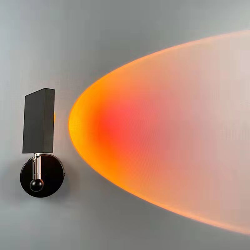 Applique murale LED Lumeoo SUNWALL projetant une lumière chaude de coucher de soleil sur un mur gris