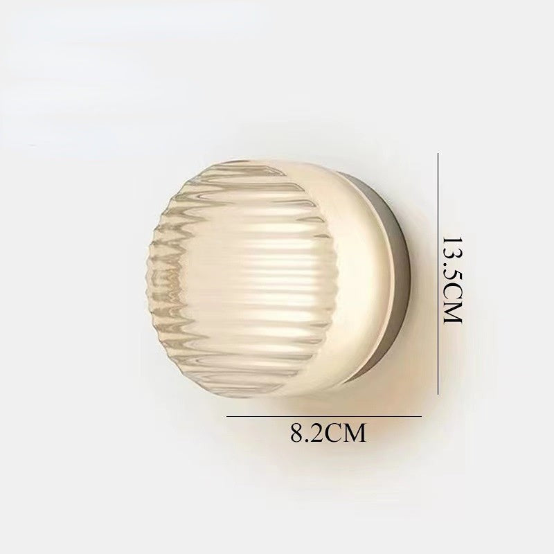 Applique murale LED ronde Lumeoo en verre texturé diffusant une lumière douce et chaleureuse pour un intérieur moderne