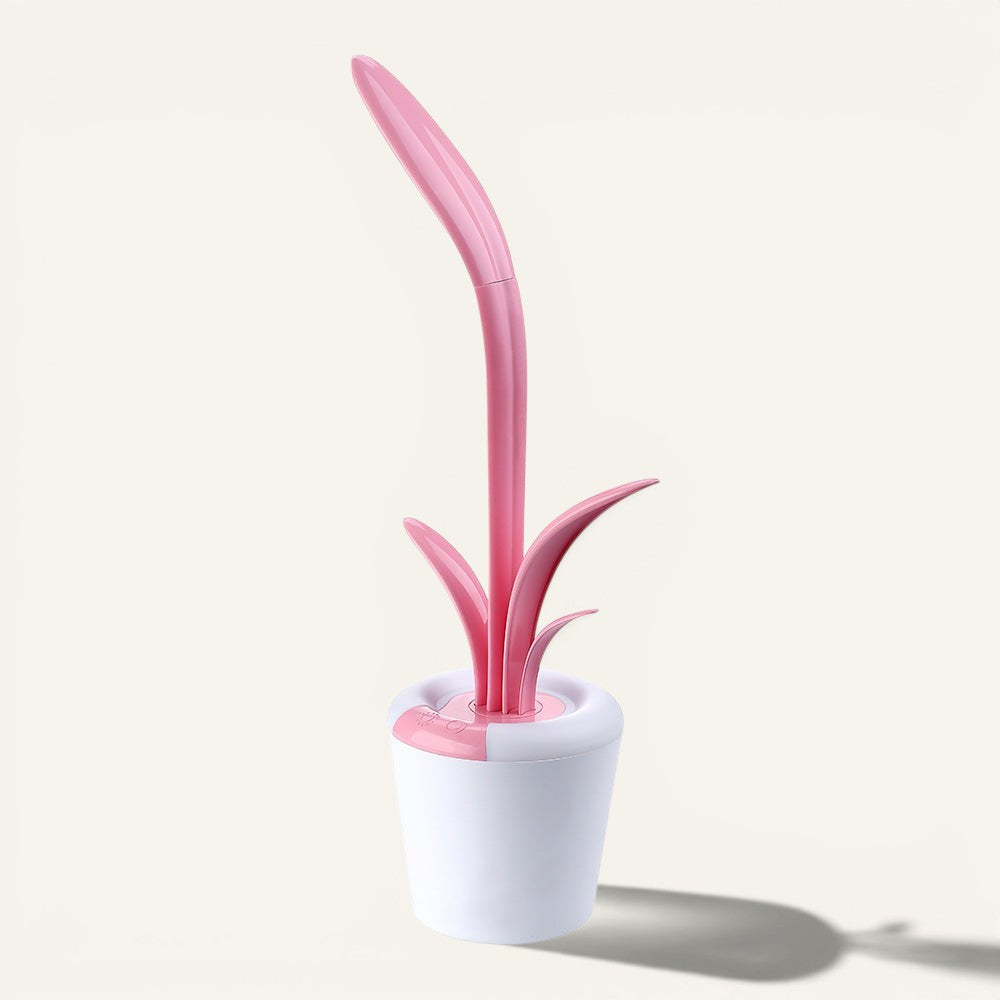 Lampe de bureau LED Lumeoo rose en forme de fleur avec base blanche, tactile, dimmable et rechargeable par USB.