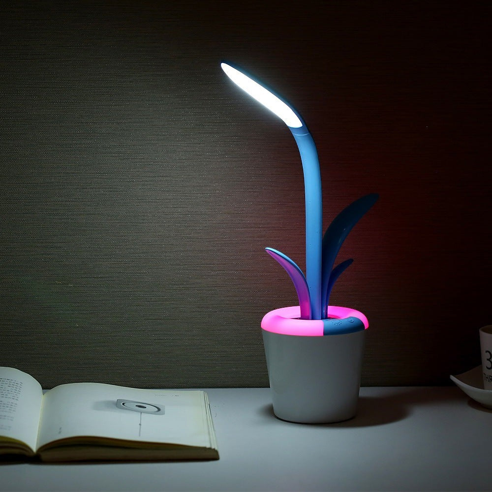 Lampe de bureau Lumeoo VISILEX LED tactile en forme de plante bleue avec socle lumineux sur un bureau