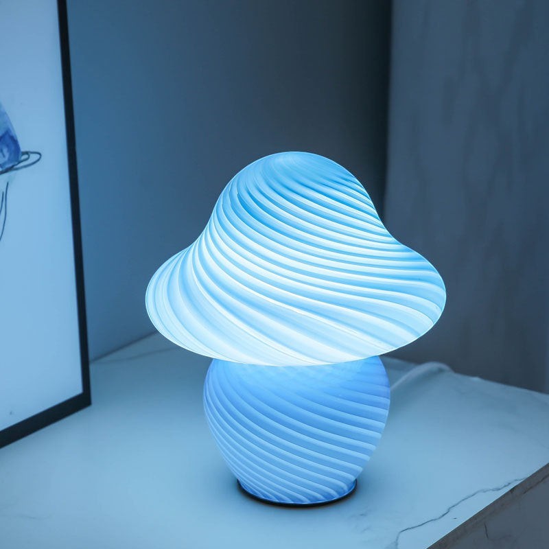 Lampe champignon Lumeoo en pâte de verre bleue avec un design torsadé diffusant une lumière douce et apaisante