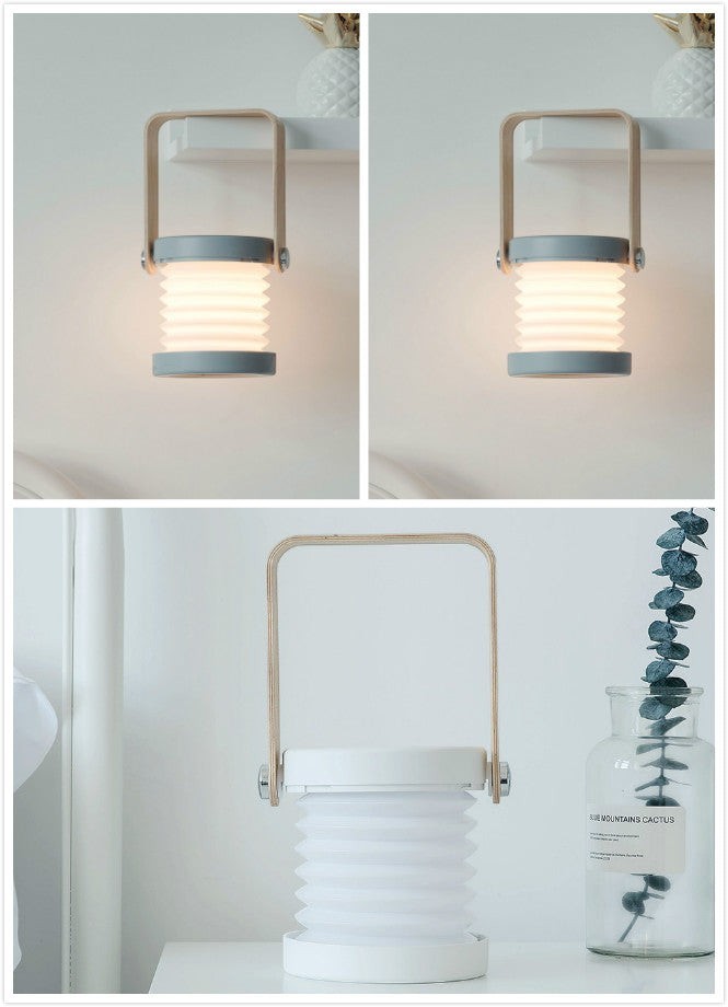 Lanterne LED Lumeoo pliable et tactile, rechargeable USB, design moderne avec anse en bois pour une ambiance cosy.