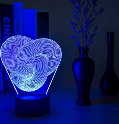 Lampe LED 3D Lumeoo en acrylique avec motif torsadé lumineux bleu, idéale comme veilleuse design pour chambre.