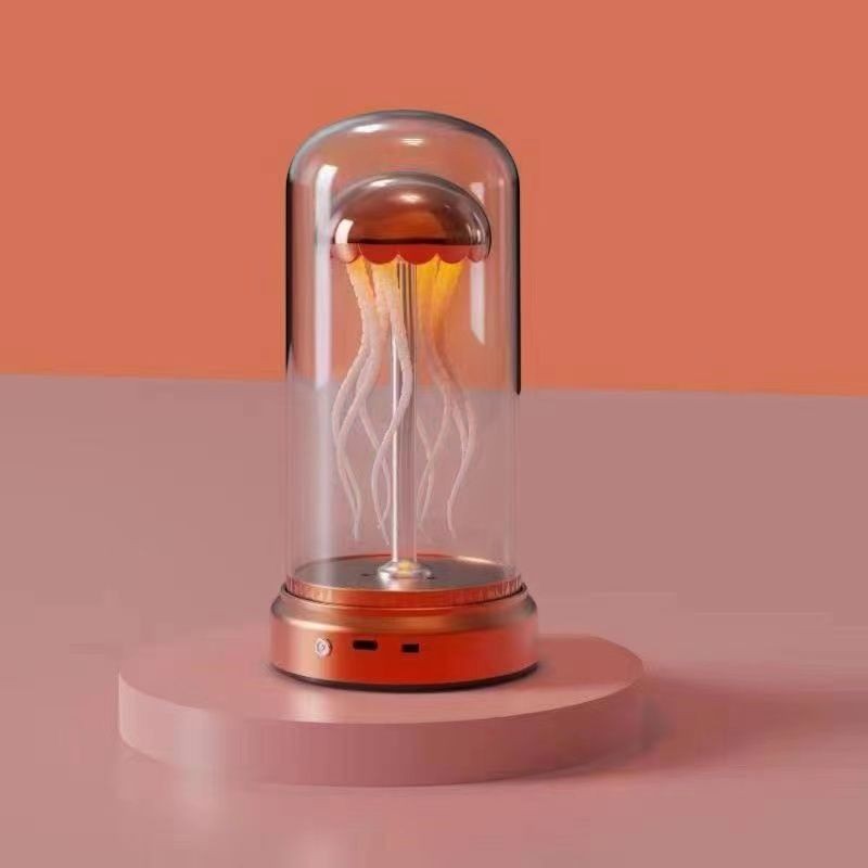 Lampe d'ambiance méduse Lumeoo avec dôme en verre, base orange et éclairage doux pour une décoration relaxante