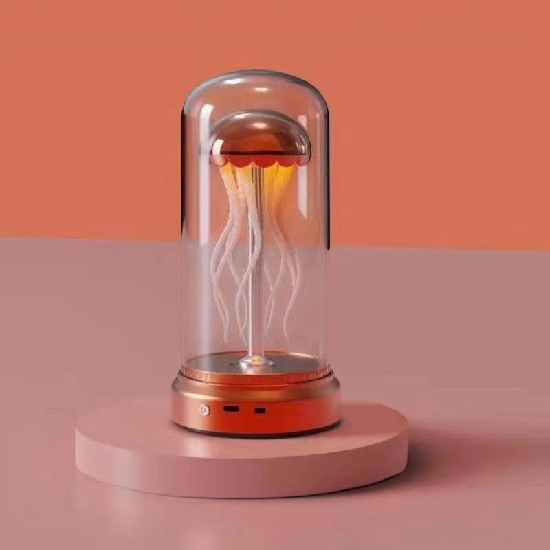 Lampe d'ambiance méduse Lumeoo avec dôme en verre, base orange et éclairage doux pour une décoration relaxante