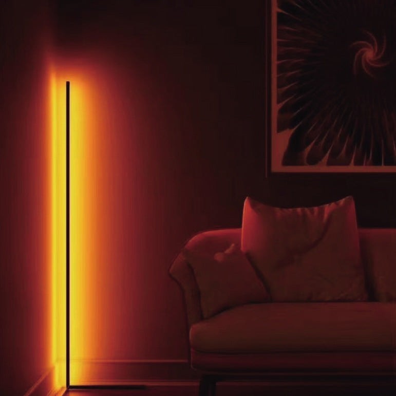 Lampadaire sur pied Lumeoo RGB connecté diffusant une lumière chaude et orangée dans un salon moderne
