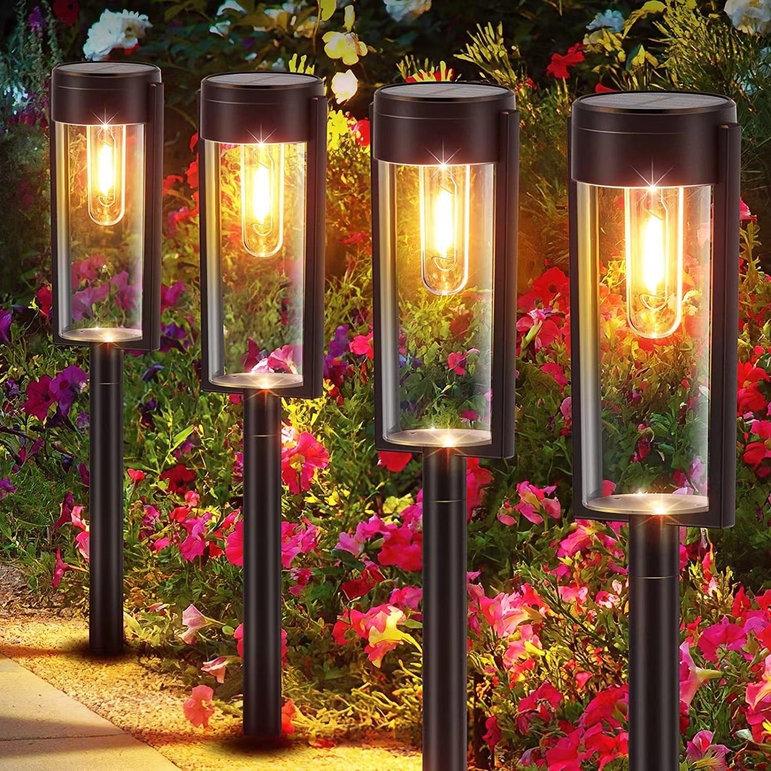 Quatre lampes solaires Lumeoo à piquer avec filament tungstène, éclairage chaud pour jardin et allée fleurie Image
