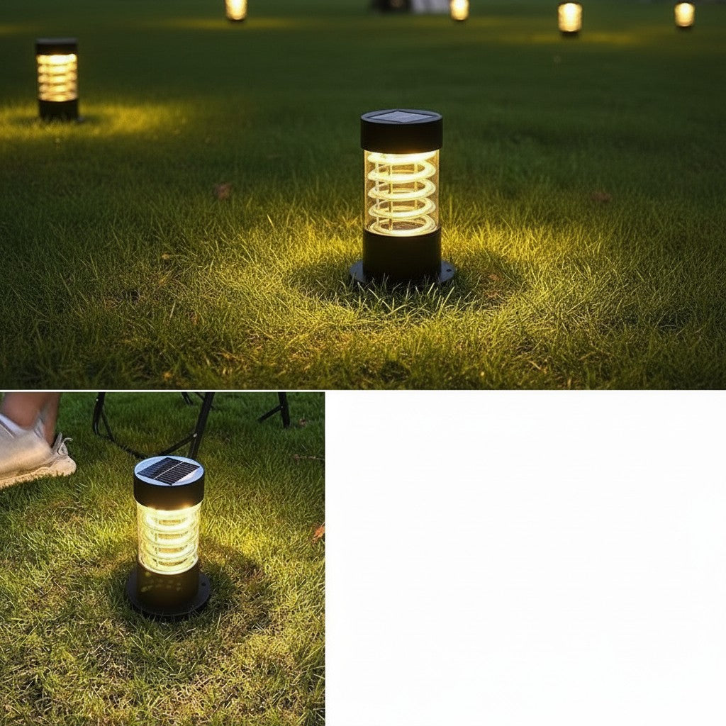 Lampe solaire extérieur à poser Lumeoo cylindrique noire avec éclairage LED chaud sur une pelouse de jardin