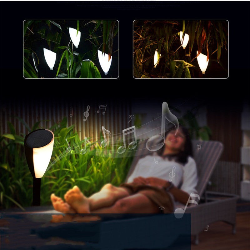 Lampe solaire Lumeoo bicolore avec haut-parleur intégré pour jardin, diffusant une lumière douce et de la musique.