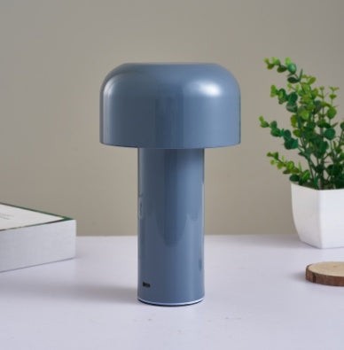 Lampe de table champignon tactile Lumeoo bleue au design moderne et épuré sur une table