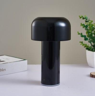 Lampe de table champignon Lumeoo noire tactile au design minimaliste et moderne posée sur un bureau