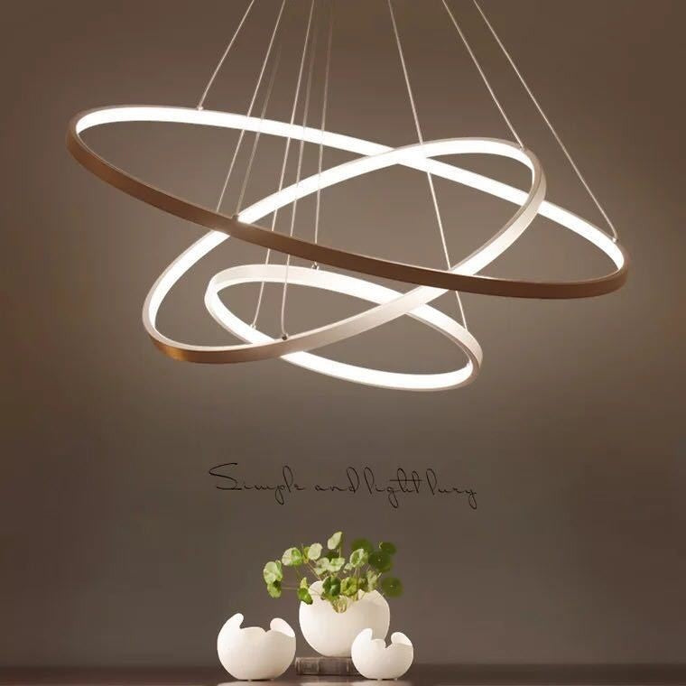 Suspension moderne Lumeoo CIRCOLUX avec trois anneaux LED circulaires entrelacés diffusant une lumière douce