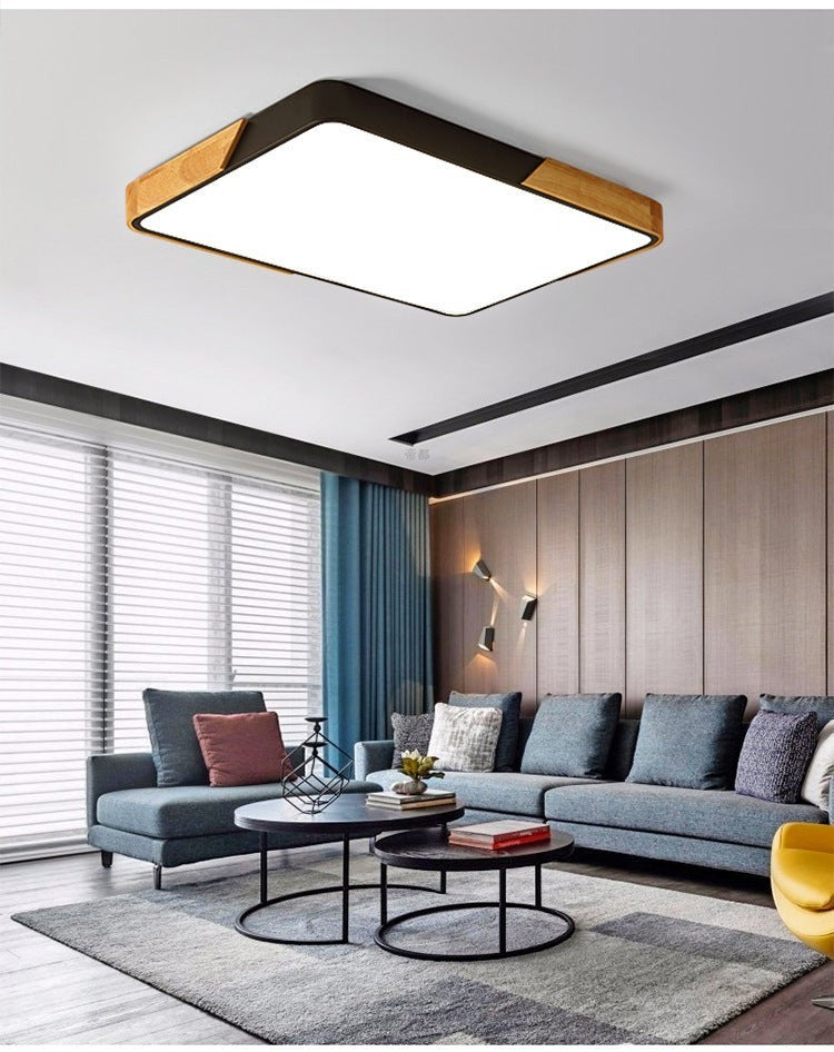 Plafonnier LED Lumeoo rectangulaire au design nordique avec cadre en bois et métal noir dans un salon moderne
