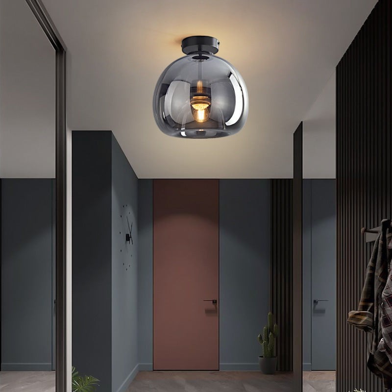 Plafonnier LED Lumeoo en verre fumé gris avec base noire, design moderne et luxueux pour un intérieur élégant.