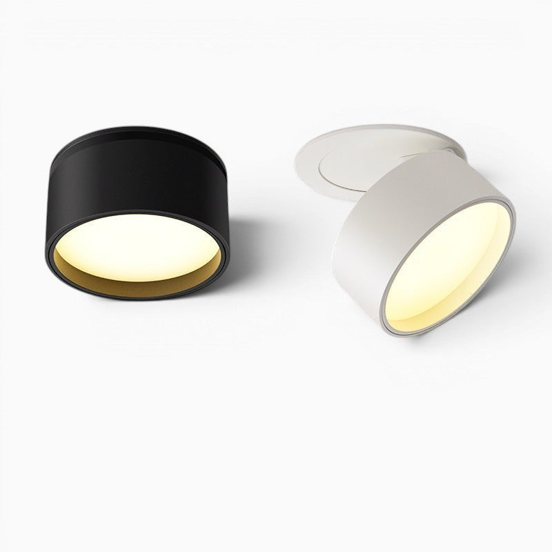 Deux spots LED encastrables orientables Lumeoo, l'un noir et l'autre blanc, fixés au plafond pour un éclairage moderne.
