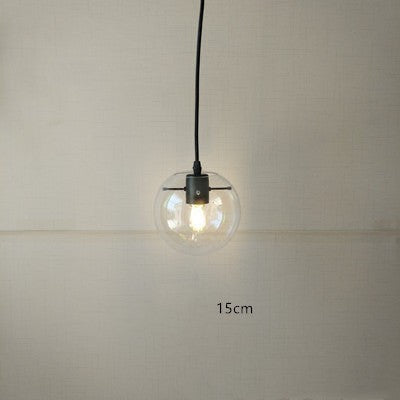 Suspension luminaire boule en verre transparent Lumeoo avec monture noire pour un éclairage élégant et chaleureux
